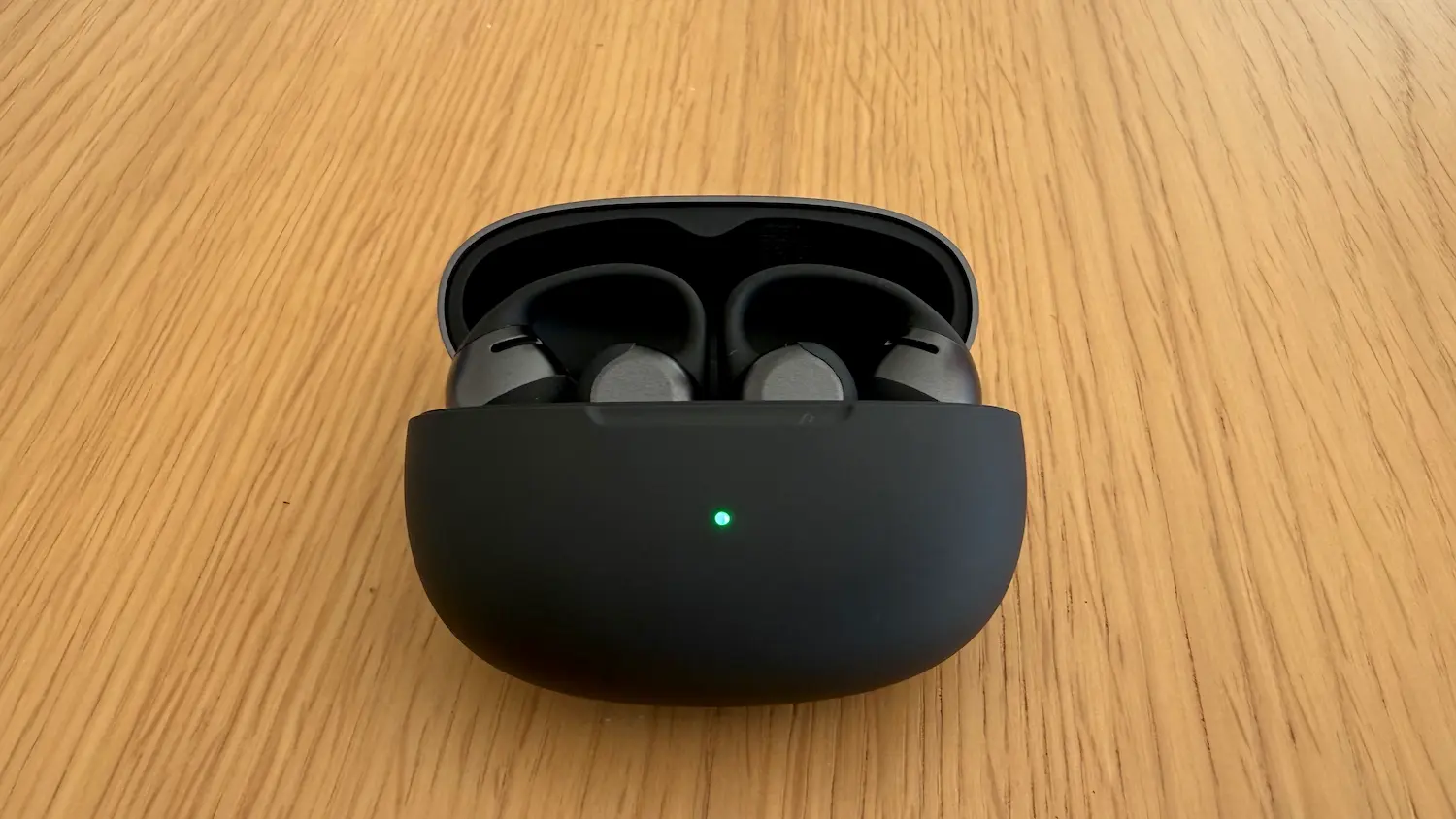Écouteurs Shokz OpenDots 2 dans leur boîtier de recharge ouvert