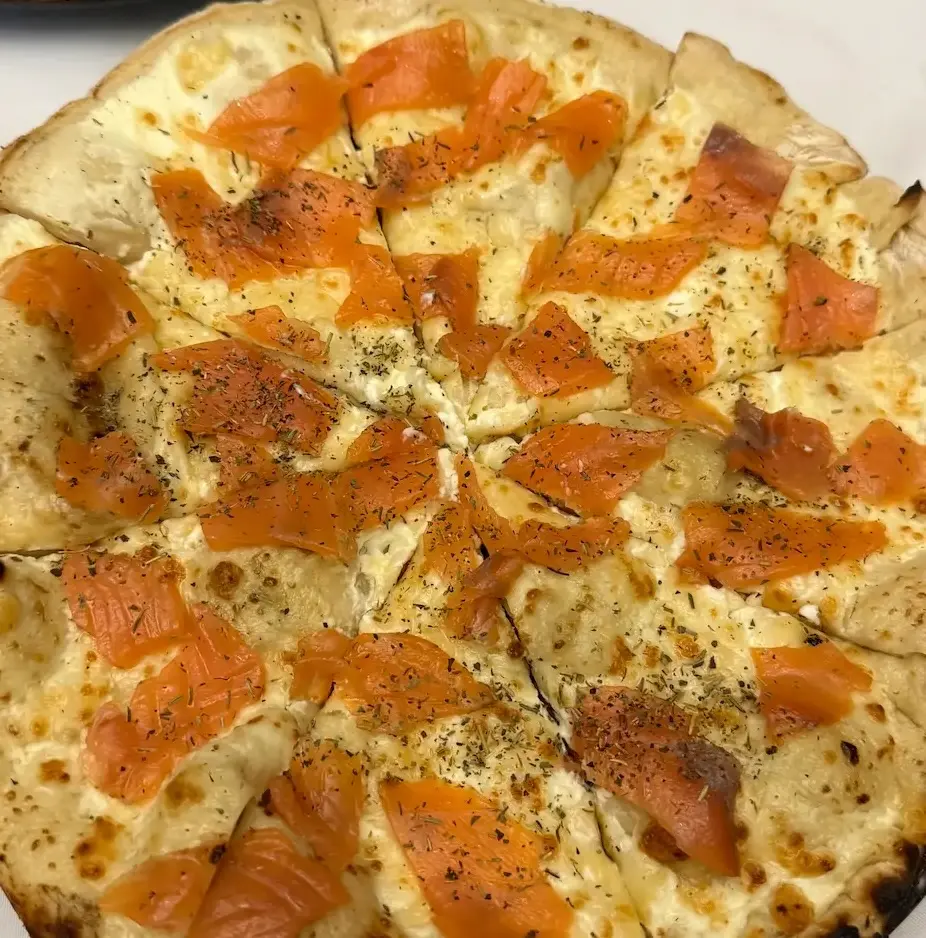 Pizza saumon maison cuite au feu de bois dans le four Mimiuo